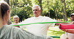 Senior group, coach and resistance band with exercise in nature for workout class or training. Elderly people, fitness or stretching with personal trainer for flexibility, health or wellness in park