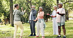 Woman, coach and senior group with dumbbells for arm exercise, training or workout together in park. Female person, personal trainer or elderly people with weightlifting on grass field for health