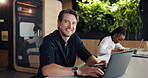 Face, happy man and typing in hybrid office with laptop for graphic design career, project and idea. Creative, person and digital designer in coworking space with computer, research and visual media.