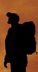Man, silhouette and mountain view with thinking, sunset sky or backpack for travel on summer adventure. Person, outdoor and perspective with reflection, bag or sightseeing on hill on trekking journey