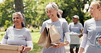 Volunteer, walk or people in park with donations, social chat or collaboration in food drive campaign. Stroll, laughing or team outdoor with package, discussion or distribution in charity project.
