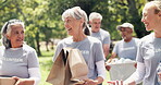 Volunteer, walk or team in nature with donations, social chat or collaboration in relief campaign. Stroll, conversation or people in park with packages, connection or distribution in charity project.