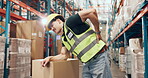 Logistics, back pain or man in depot with accident, spine massage or emergency in supply chain. Ache, flare or loader in warehouse with injury, muscle strain or osteoarthritis in distribution.