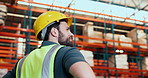 Man, thinking and reflection at warehouse for storage, logistics or inspection with low angle. Person, technician and smile with perspective for safety check, inventory management and distribution