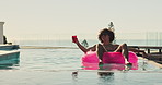 Float, drink and man in pool at holiday home for relax in summer on vacation or weekend trip. Dancing, calm and male person on inflatable with alcohol beverage in water for sunbathing at resort.