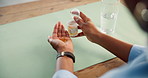 Person, hands or capsules with glass of water for medication, omega vitamin or antibiotic in home. Top view, patient or user with immune booster, pill or drink for health or pharmaceutical in house