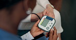 Hands, patient and blood pressure monitor on sofa for assessment, nurse or hypertension in retirement home. Senior person, caregiver and above screen for results on tech, exam or healthcare in house
