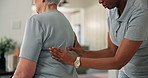 Physiotherapy, back massage and chiropractor with senior woman in office for injury rehabilitation. Consultation, assessment and physical therapist with elderly patient for shoulder pain in clinic.