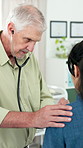 Consultation, doctor and woman in hospital, stethoscope and discussion for symptoms. Mature people, medical service and patient in clinic, wellness and appointment for lung health or breathing test