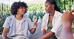 Happy friends, wine and picnic outdoor with chat for social gathering, connection and bonding together. People, laugh and talking with alcohol drink in nature for gossip, summer vacation and hangout.