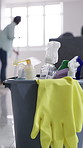 Gloves, cleaning supplies and bucket in home for hygiene, disinfection and household chores. Detergent, spray bottle and materials for tidying with bacteria, germs or dirt removal in apartment.