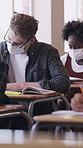 Classroom, students or teenager with mask for education, safety measure or academic assessment. Concentration, problem solving or boy with knowledge for assignment, infection prevention or school