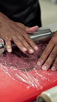 Tenderize meat, hands and man in kitchen, chef and rolling pin with plastic, skills and technique. Closeup, food industry and person with ingredients, catering or process for cooking steak or flatten