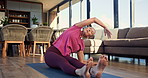 Woman, stretching and fitness on mat, home and workout routine in living room, warm up and wellness. Healthy, mature person and exercise preparation on floor, balance and flexibility for pilates