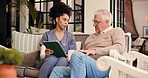 Senior man, nurse and wheelchair with tablet for diagnosis, support or assisted living in home. Healthcare, caregiver and helping elderly male person with a disability for health advice in house