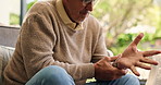 Old man, hand pain or arthritis in home with stretching fingers for discomfort, carpal tunnel or injury. Senior person, massage wrist or joints in house for inflammation, osteoporosis or health issue