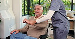 Physical therapy, stretching and caregiver with old man in wheelchair for mobility, health and arthritis in home. Retirement, help and nurse with elderly person with disability for medical support