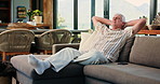 Relax, morning and senior man on sofa in home for chilling, comfortable and enjoy calm on Sunday afternoon. Retirement, phone and mature person on couch for resting, lazy and peaceful in living room