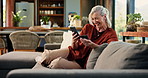 Phone, credit card and senior woman on sofa in home with online shopping, ecommerce or payment. Laugh, technology and elderly female person with cellphone for purchase on website in living room.