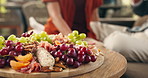 Charcuterie board, home and old couple with love, food and bonding together with anniversary. Closeup, man and woman with snack platter, fruits and celebration with romance, marriage or healthy treat