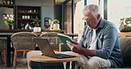 Typing, laptop and tablet with old man on sofa for mortgage payment, retirement funds and planning. Online banking, digital invoice and research with senior person in home for pension account