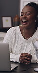 Influencer, laughing and woman with laptop, podcast and listening with headphones or live streaming. Home office, podcaster and black person with tech for broadcast, social media and talking with mic