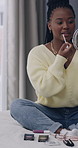 Influencer, recording and black woman with makeup in home for application, how to and tutorial. Content creator, social media and person with cosmetics for product review, beauty tips and lipgloss