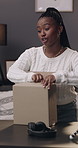 Black woman, influencer and unboxing in home, talk or remove tape for audience, product and review. African person, cardboard package and presenter on social media, live stream or mystery for video
