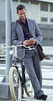 Businessman, phone and texting with bicycle in city for commute, smile and notification on web. Person, smartphone and happy with eco friendly transport, mobile app and break on travel in urban town