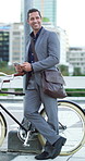 Businessman, phone and texting with bike in city for commute, smile and thinking on trip Person, smartphone and contact with eco friendly transport, mobile app and bicycle on travel in urban town