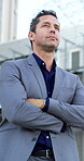 Arms crossed, thinking and business man in city for real estate developer, reflection and morning commute. Urban property venture, low angle and travel with person outdoor for realtor expansion
