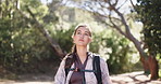 Woman, hiking and outdoor exploration on trail for tourist adventure, wellness and journey in forest. Female person, trekking or walking with backpack for travel, holiday activity and nature scenery.