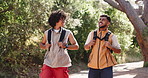 Men, laugh and smile with hiking outdoor for bonding, conversation and support in woods. Friends, discussion and together with comedy for exercise, wellness and walk in nature for adventure or travel