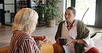 Friends, home and women with coffee, talking and relax with gossip, happy and conversation on break. Mature people, discussion and together with tea in lounge, smile and listening to story in house