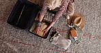 Above, packing and woman with suitcase in home to prepare for travel, vacation and leaving for trip. House, top view and senior person with clothing, passport and luggage for tourism and holiday