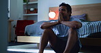 Frustrated, man and thinking in bedroom, night and stress for financial crisis, sad or mental health. Emotional, reflection and anxiety for job loss in home, late and person with depression and debt