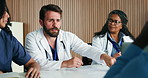 Man, talking and doctors in clinic, healthcare and feedback for team schedule. People, medical service and employees with discussion, meeting or review for medicare compliance  and hospital agenda