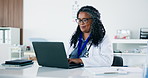 African woman, doctor and laptop in office for research, medical report and patient history. Mature person, pc and clipboard for Telehealth, healthcare records and information for treatment procedure