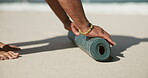 Beach, hands and rolling yoga mat on sand, finish exercise or end of meditation practice for packing. Fitness, outdoor or person with done holistic routine for wellness, clearing equipment and nature
