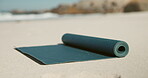 Fitness, yoga and mat on beach with preparation, setup or equipment for wellness activity. Start, empty area or session at ocean with support pad, outdoor workout or beginning of pilates training.