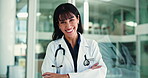 Medical, face and mature woman in hospital with arms crossed, job goals or pride in healthcare. About us, laugh or doctor in clinic with confidence, general practitioner or experience in wellness.