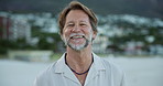 Smile, beach and face of mature man on summer holiday, getaway or weekend trip with positive attitude. Happy, relax and portrait of male person by ocean for vacation or retreat with calm in Australia