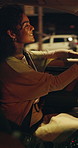 Night, driving and woman in car on city street, business trip and transportation to work destination. Travel, urban navigation and happy person in vehicle for commute, town road and late journey