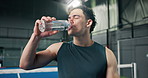 Man, fitness and drinking with water in padel court for hydration, sport or workout break. Thirsty, active or male person with mineral liquid or bottle for sustainability, recovery or rest on turf