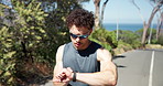 Nature, smart watch and man with running for workout, training or wellness in morning. Sunglasses, fitness tech and male athlete with heart rate tracking for cardio exercise in park for practice.