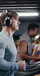 Headphones, runner and man on treadmill in gym for fitness, exercise or training with music. Audio tech, equipment and male person on machine for cardio workout with playlist in sports center. 