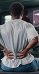 Man, fitness and back pain with muscle tension in gym for overworked strain or pressure. Active, male person or sore spine with discomfort for joint inflammation or workout accident in health club