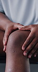 Knee pain, gym and hands of person with injury from training, workout and exercise. Closeup, massage and athlete with sprain, tension and mistake for fitness, risk and accident in sports center
