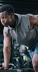 Fitness, weights and black man in gym with workout, bodybuilding or training for strength. Equipment, strong and African male athlete with dumbbells for exercise with arm muscles in sports center.