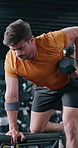Dumbbell, weightlifting and man in gym for workout, training and fitness for endurance goals. Bodybuilder, person or athlete with arm strength, power exercise or health challenge in sports center